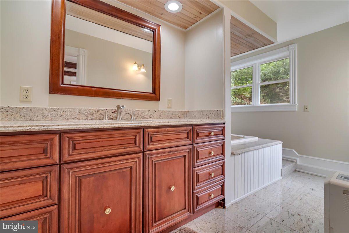 3585 Fairyland Road Lehighton, PA 18235 - Photo 35 of 109 a bathroom with a sink a vanity and a mirror