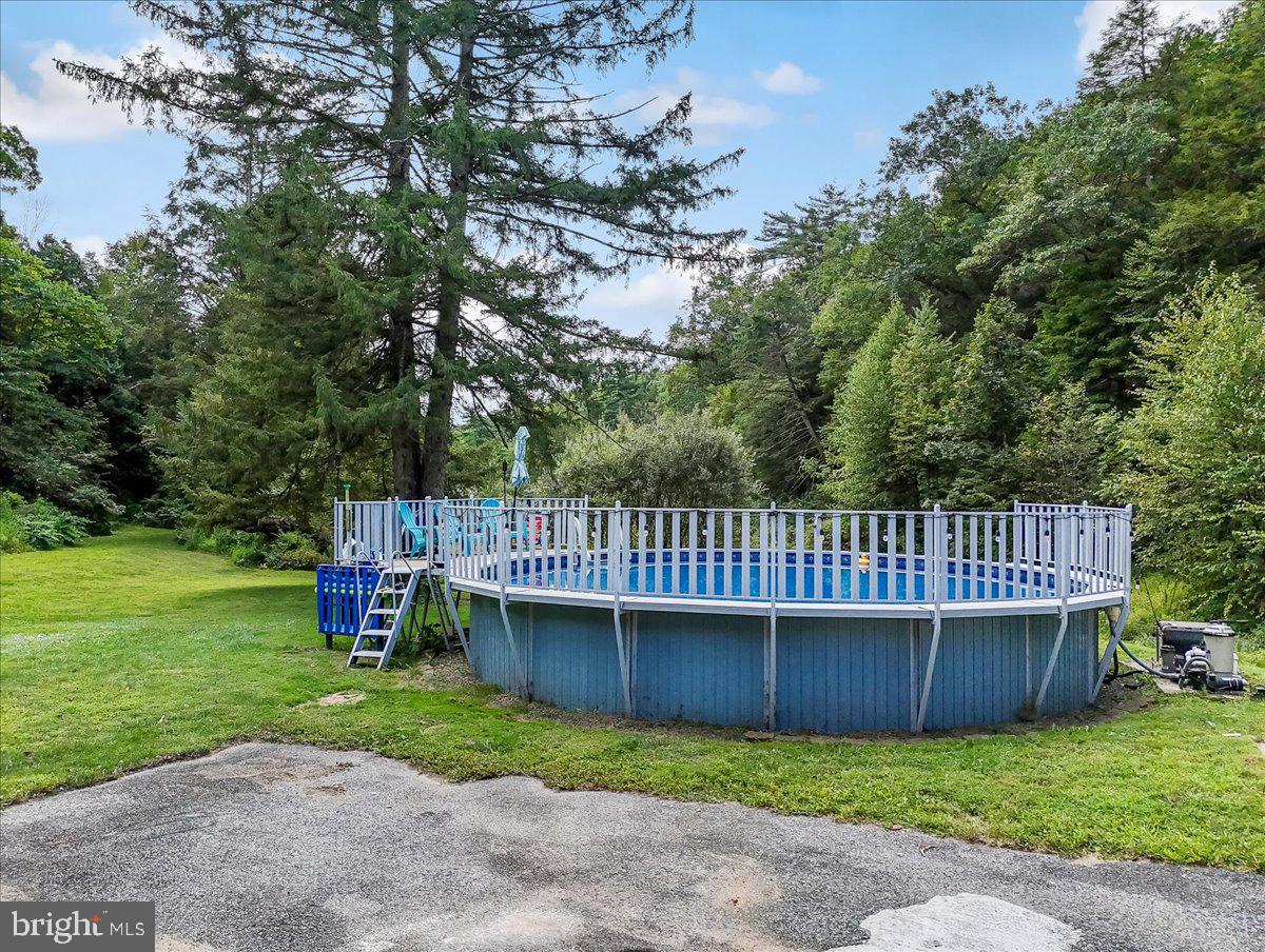 3585 Fairyland Road Lehighton, PA 18235 - Photo 72 of 109 a view of a deck with a big yard potted plants and large tree