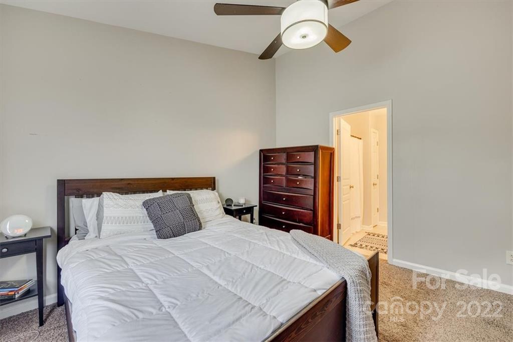 931 Copperstone Lane Fort Mill, SC 29708 - Photo 22 of 30 a bedroom with a bed and a chandelier