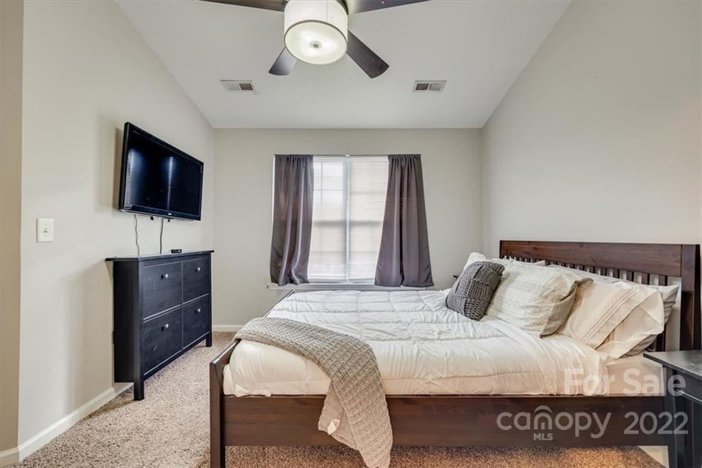 931 Copperstone Lane Fort Mill, SC 29708 - Photo 23 of 30 a bedroom with a bed and a flat screen tv