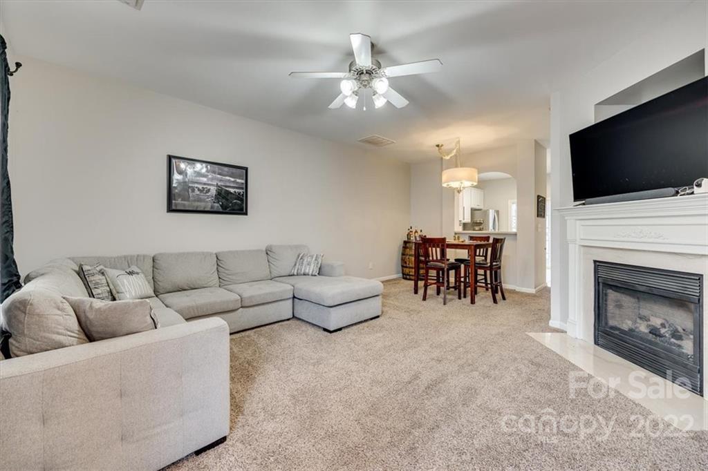 931 Copperstone Lane Fort Mill, SC 29708 - Photo 4 of 30 a living room with furniture a flat screen tv and a fireplace