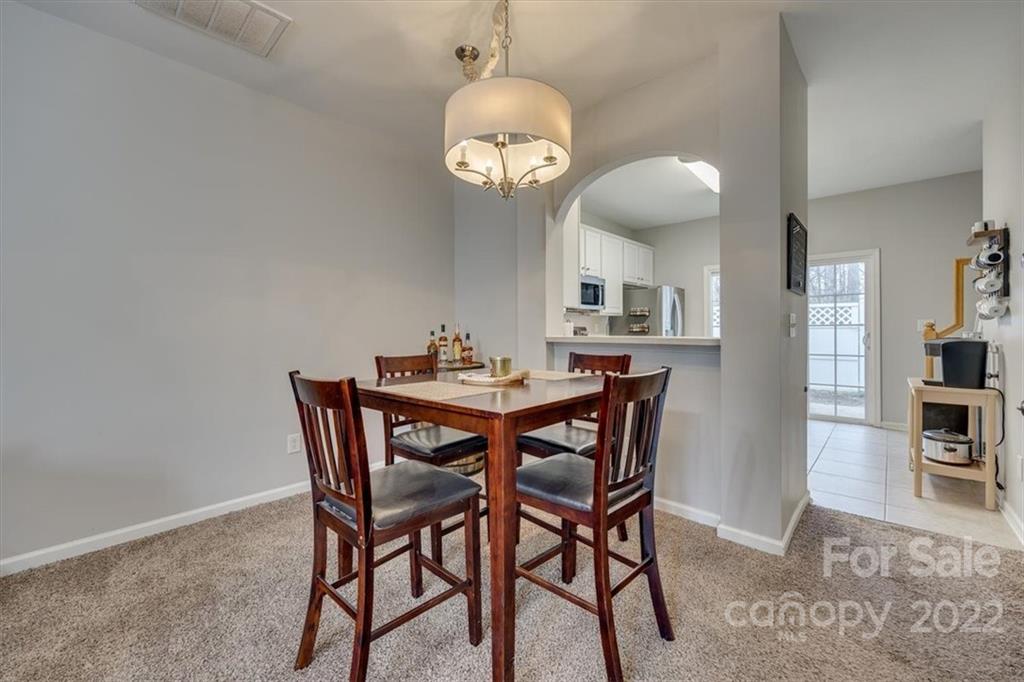 931 Copperstone Lane Fort Mill, SC 29708 - Photo 8 of 30 a dining room with a wooden table and chairs