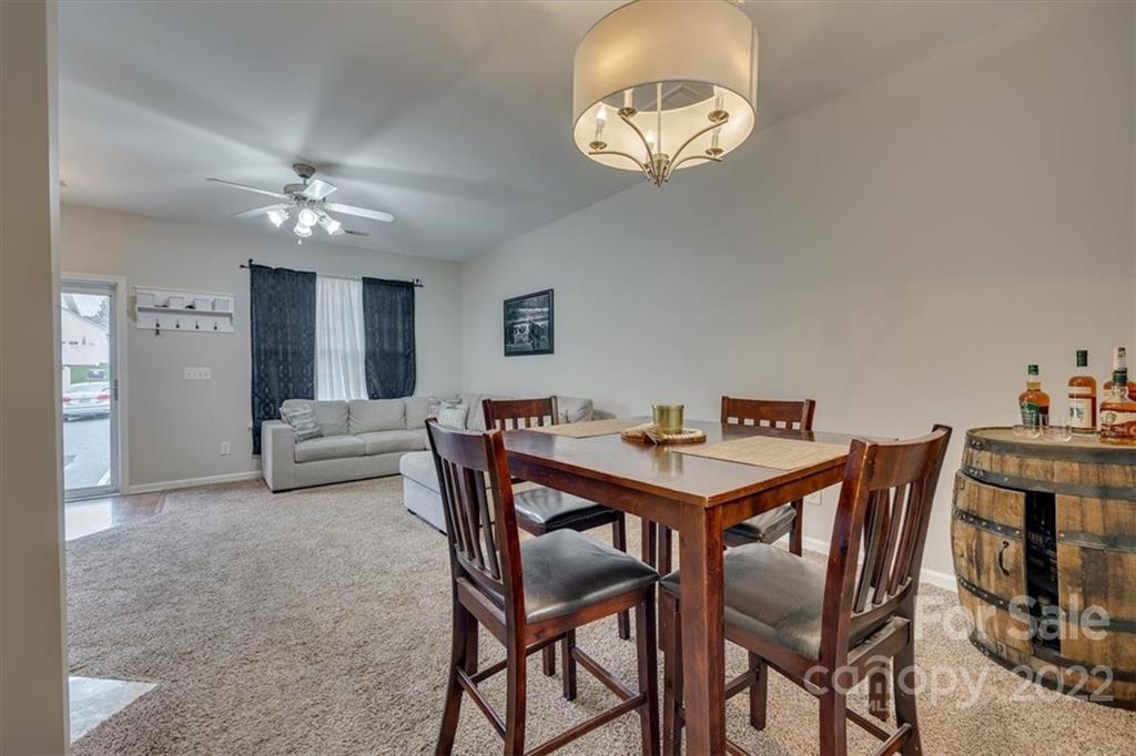 931 Copperstone Lane Fort Mill, SC 29708 - Photo 9 of 30 a view of a dining room with furniture and chandelier