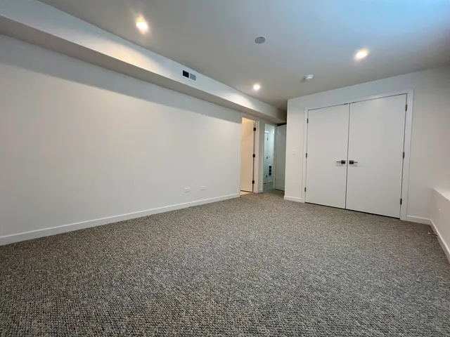 a spacious bathroom with a double vanity sink mirror and toilet