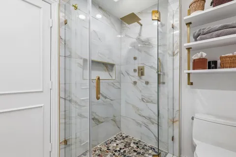 a bathroom with a shower and a sink