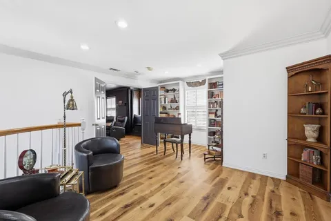 a living room with furniture a dining table and a bookshelf