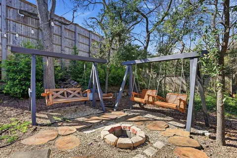 a view of a patio with a dining table and chairs with wooden floor and fence