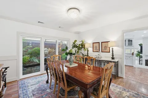 a dining room with furniture a window and a rug