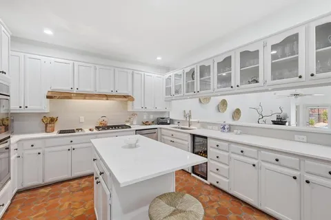 a kitchen with a sink a stove and cabinets