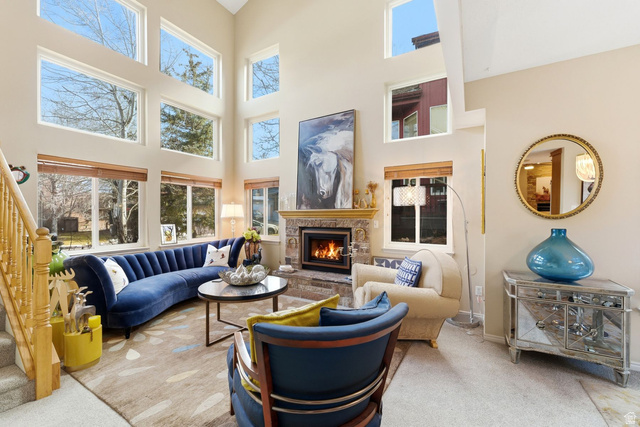 7930 Mustang Loop Road Park City, UT 84098 - Photo 2 of 23 Living area with a fireplace, carpet, healthy amount of natural light, and a high ceiling