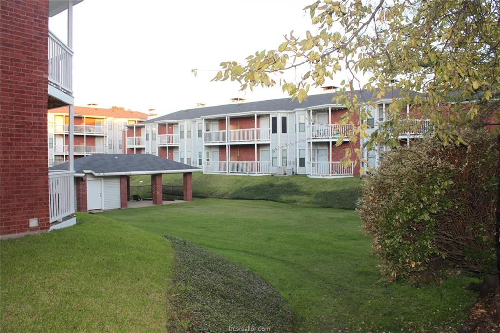 a view of a house with a yard and sitting area