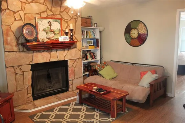 a living room with furniture and a fireplace