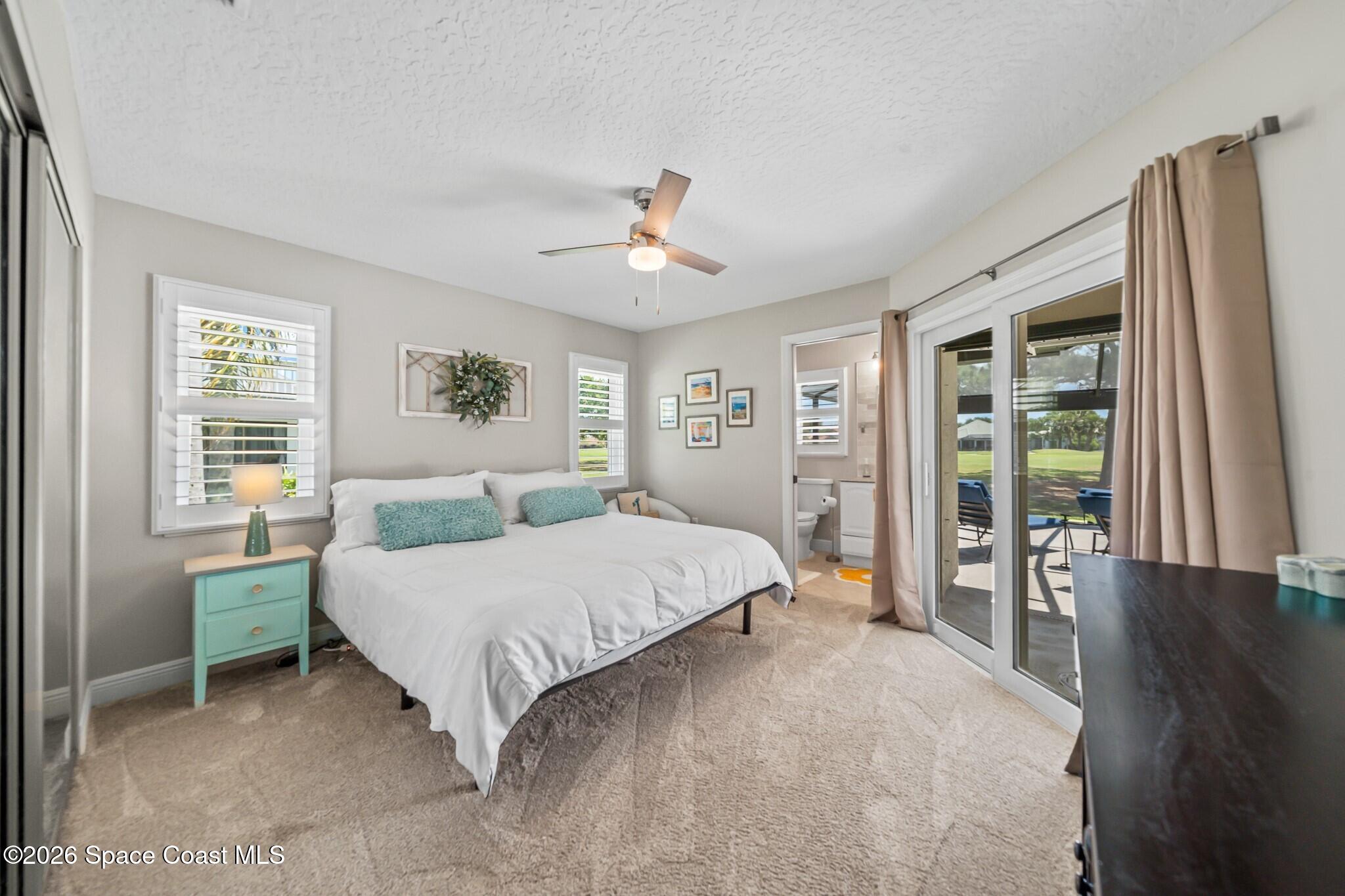 697 Spring Lake Drive Melbourne, FL 32940 - Photo 26 of 45 a bedroom with a large bed and a chandelier
