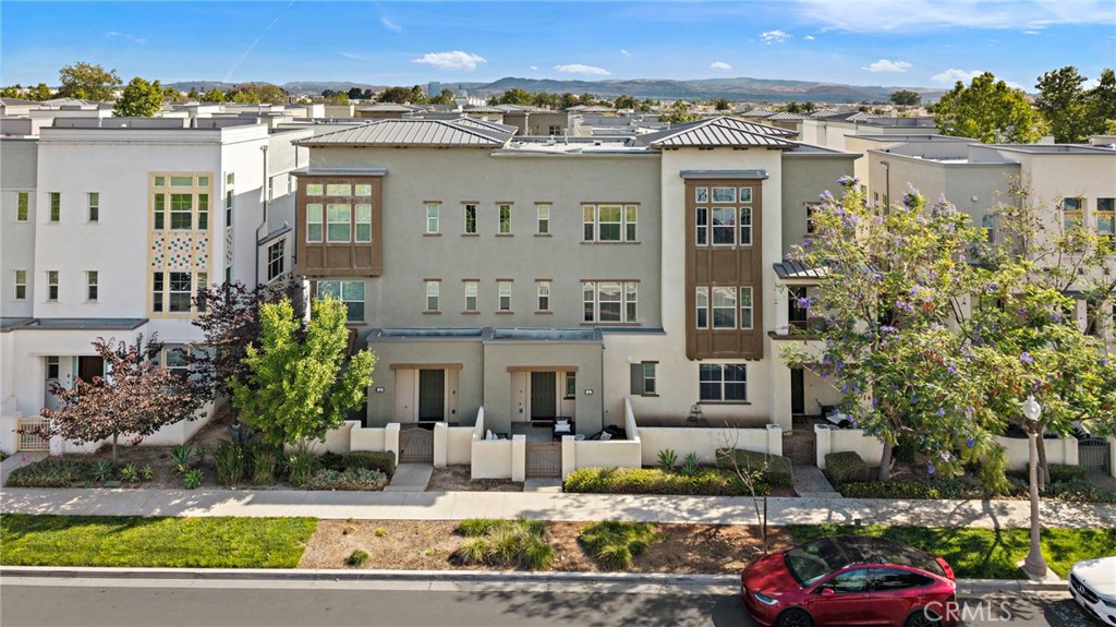 144 Paramount Irvine, CA 92618 - Photo 27 of 43 a view of a building with a yard and plants