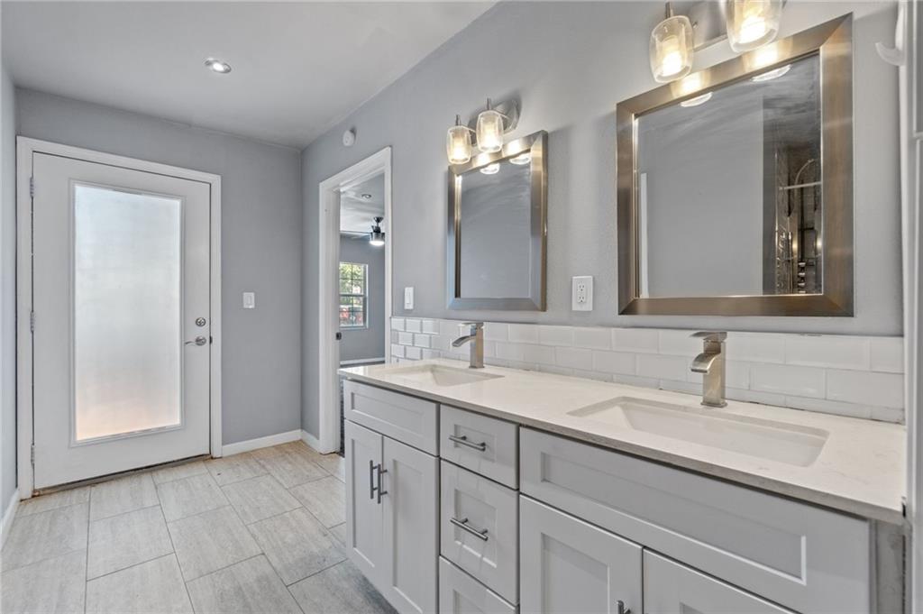 2105 Fortview Road Austin, TX 78704 - Photo 25 of 37 Dual vanities with modern fixtures and ample storage elevate daily routines in this well-appointed bathroom.