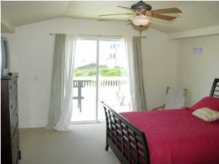 6050 Hwy Santa Rosa Beach, Unit 30A Santa Rosa Beach, FL 32459 - Photo 12 of 23 a bedroom with a bed and a chandelier