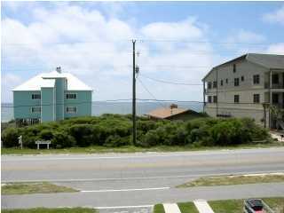 6050 Hwy Santa Rosa Beach, Unit 30A Santa Rosa Beach, FL 32459 - Photo 18 of 23 a view of a tall building next to a yard