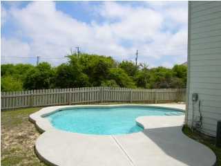 6050 Hwy Santa Rosa Beach, Unit 30A Santa Rosa Beach, FL 32459 - Photo 4 of 23 a view of a backyard with a small swimming pool and wooden fence