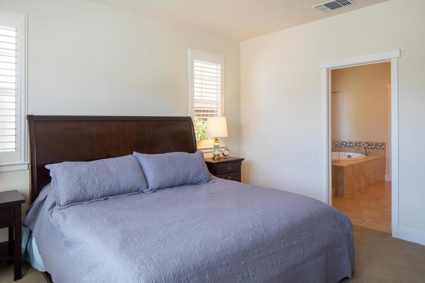 14741 Kit Carson Drive East Garrison, CA 93933 - Photo 12 of 24 a bedroom with a bed and night stand