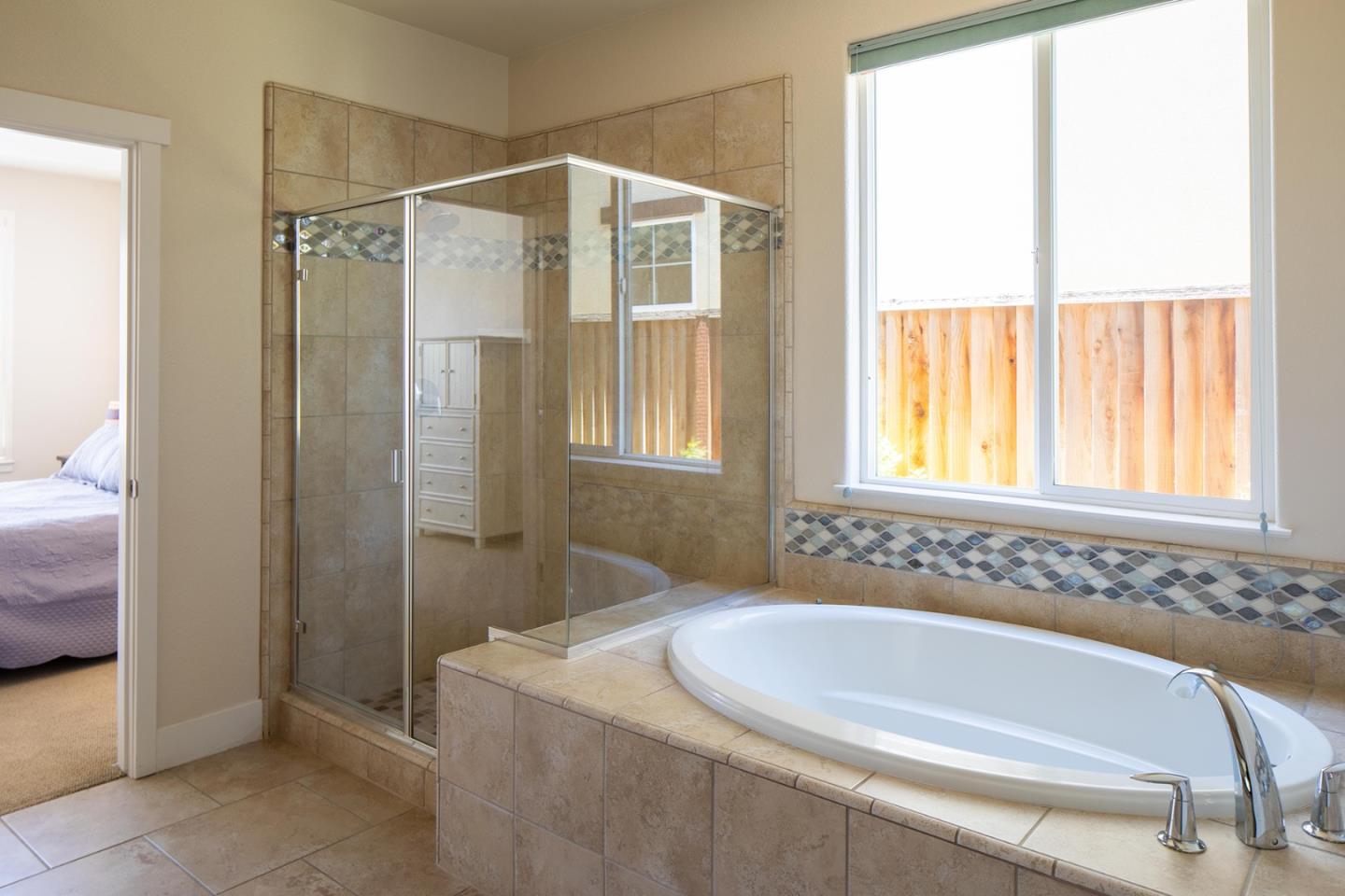 14741 Kit Carson Drive East Garrison, CA 93933 - Photo 13 of 24 a bathroom with a bathtub and a shower