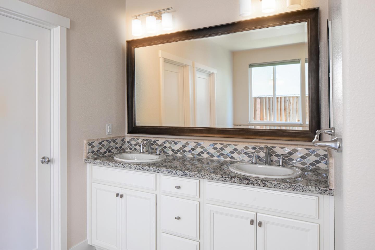 14741 Kit Carson Drive East Garrison, CA 93933 - Photo 14 of 24 a bathroom with a sink and a mirror