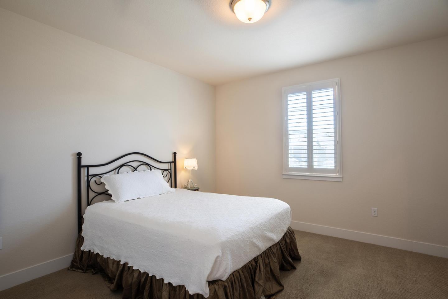 14741 Kit Carson Drive East Garrison, CA 93933 - Photo 16 of 24 a bedroom with a bed and window