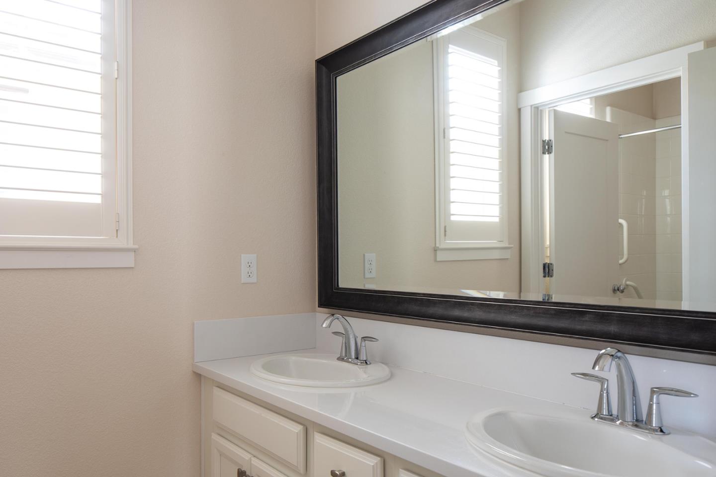 14741 Kit Carson Drive East Garrison, CA 93933 - Photo 18 of 24 a bathroom with a sink and a mirror
