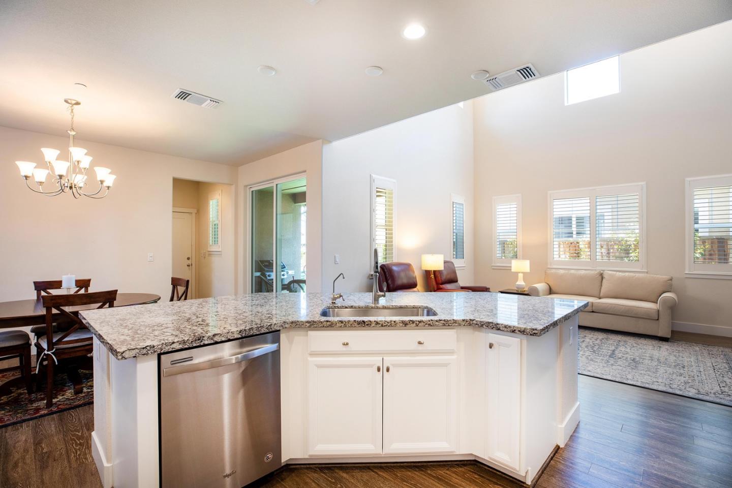 14741 Kit Carson Drive East Garrison, CA 93933 - Photo 7 of 24 a kitchen with granite countertop a sink cabinets and wooden floor