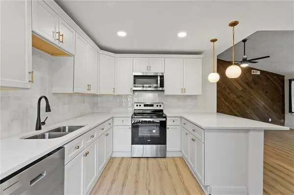 a kitchen with a sink stove and cabinets