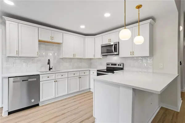 a kitchen with cabinets a sink and appliances