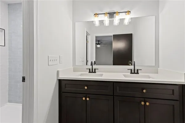 a bathroom with a double vanity sink and a mirror
