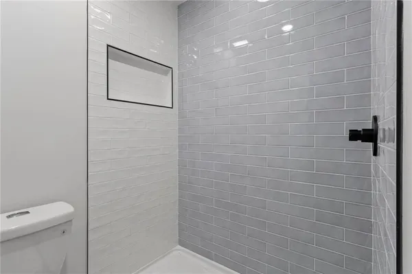 a bathroom with a toilet and a shower