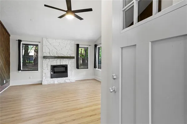a view of a livingroom with a fireplace and window