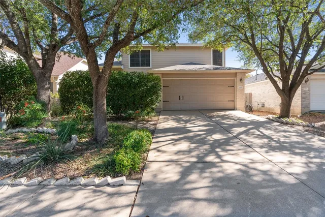 a view of a house with a tree