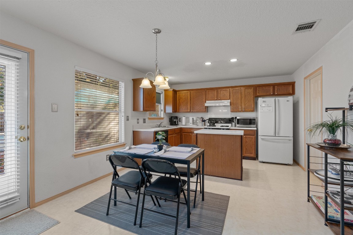 15419 Craig's Crest Path Pflugerville, TX 78660 - Photo 12 of 36 a view of a dining room with furniture window and wooden floor