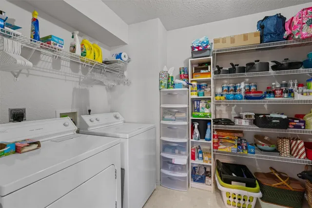 a utility room with stainless steel appliances and cabinets