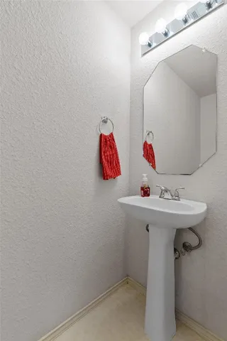 a bathroom with a sink vanity and toilet