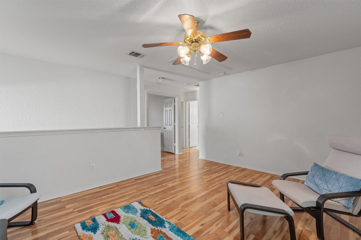 15419 Craig's Crest Path Pflugerville, TX 78660 - Photo 21 of 36 a view of a room with wooden floor and chandelier fan