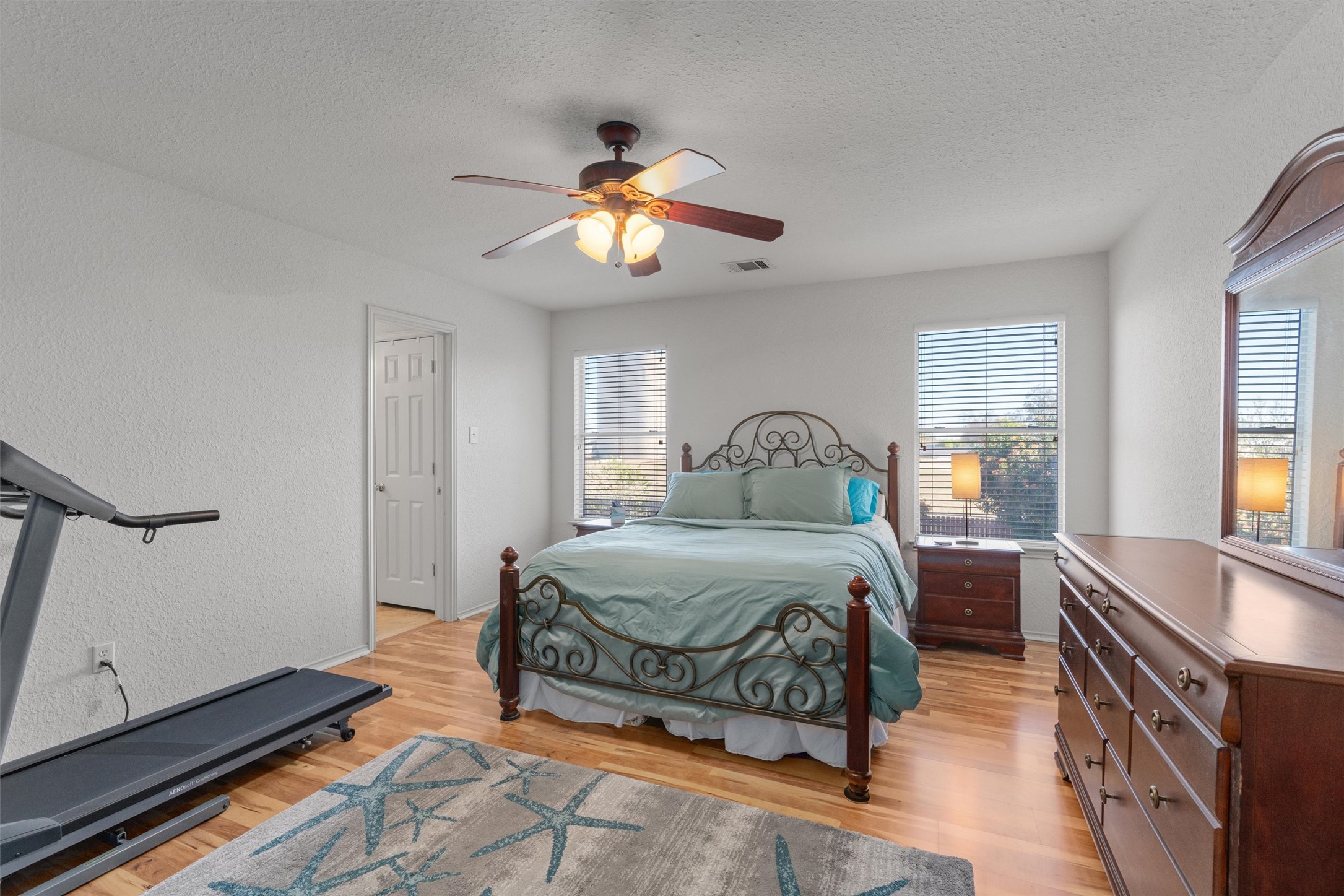 15419 Craig's Crest Path Pflugerville, TX 78660 - Photo 22 of 36 a bedroom with a bed and wooden floor