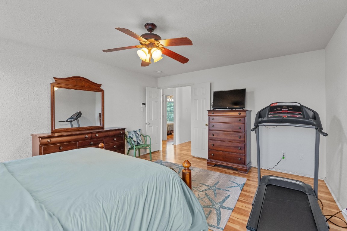 15419 Craig's Crest Path Pflugerville, TX 78660 - Photo 23 of 36 a bedroom with a bed and a chandelier
