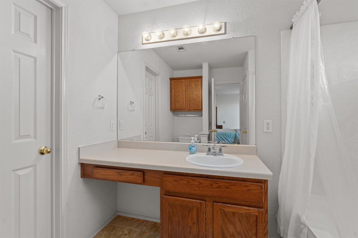 15419 Craig's Crest Path Pflugerville, TX 78660 - Photo 24 of 36 a bathroom with a sink and a mirror