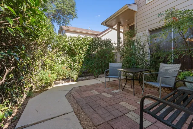 a view of a patio with table and chairs and potted plants