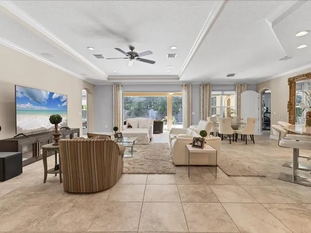 a large kitchen with stainless steel appliances granite countertop a large stove top oven a sink dishwasher and white cabinets next to a window