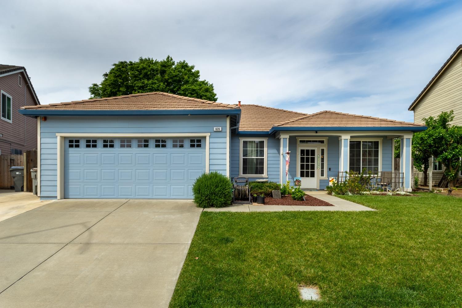 a front view of a house with a yard and porch