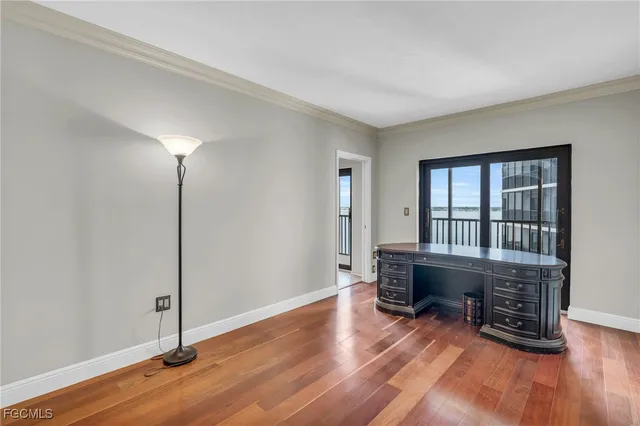 a dining room with furniture potted plants and wooden floor