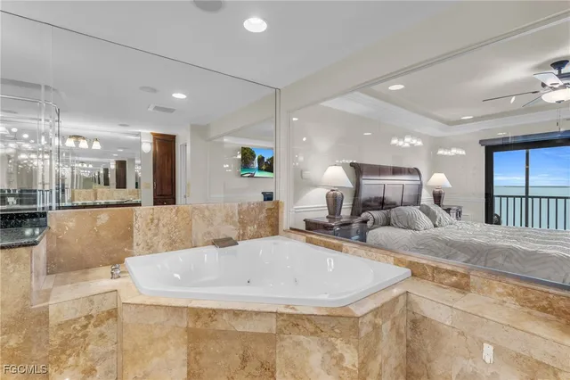 a bathroom with a large tub and shower