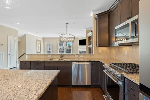 a kitchen with stainless steel appliances granite countertop a stove and a microwave