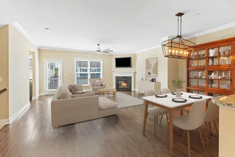 a living room with fireplace furniture and a wooden floor