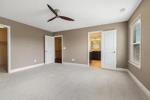 a view of a livingroom with a ceiling fan and window