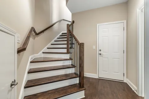 a view of entryway with wooden floor and stairs